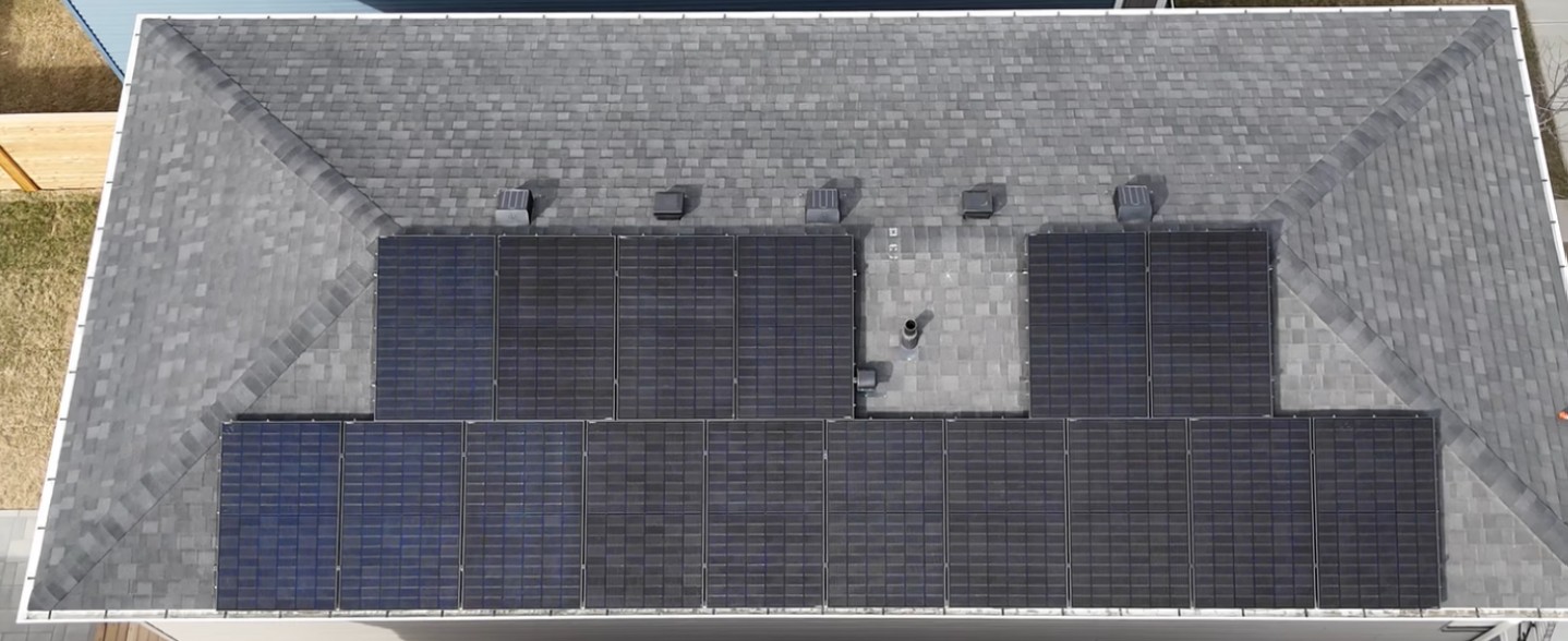 Aerial view of a large residential rooftop solar array